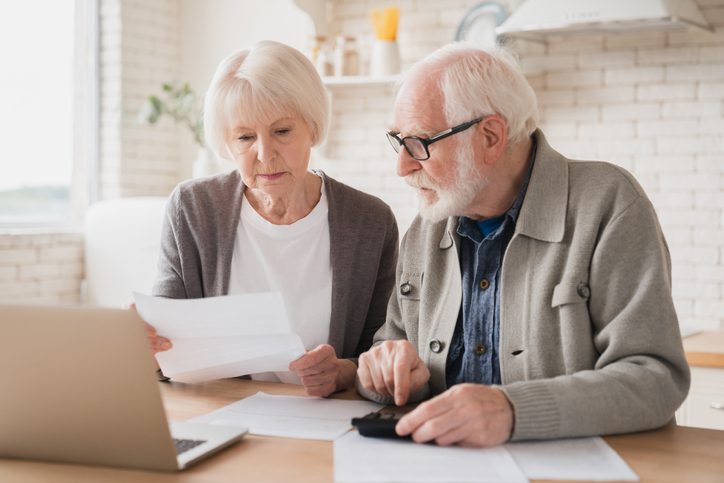 Seniors managing finances with a Guaranteed Final Expense policy.