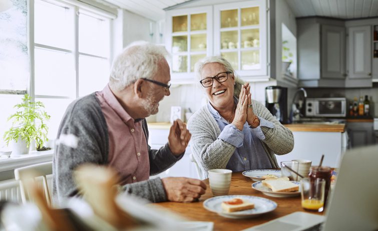 Elderly Couple discussing about financial planning includes life insurance for funeral costs.